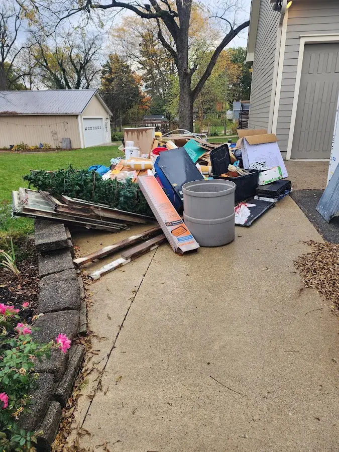 Dumpster being loaded with debris for Roofing Dumpster Rental in Woburn
